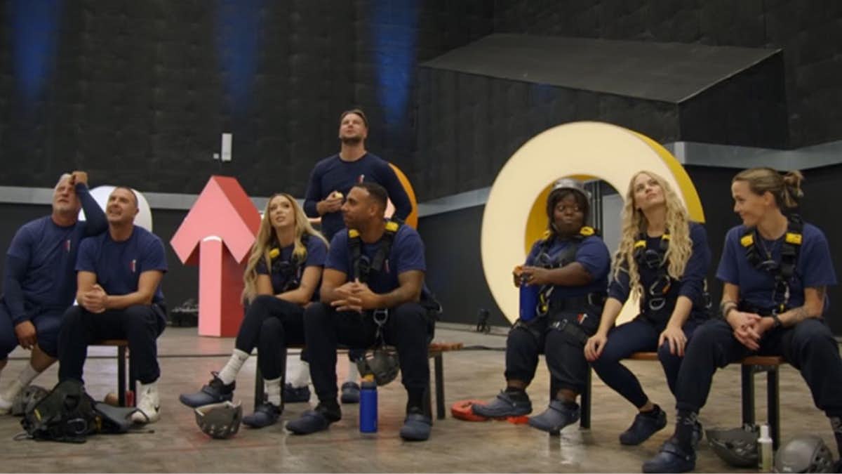 The cast of Don't Look Down for Stand Up To Cancer looking up at a climbing wall.