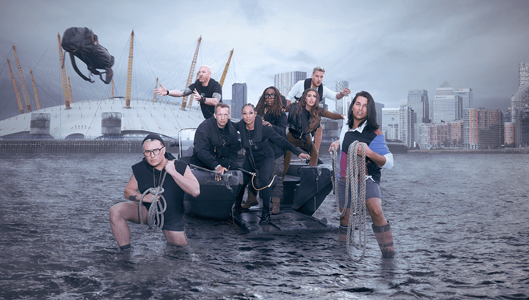 The 2022 cast of the TV show Celebrity Hunted standing in front of the O2 Arena in London.