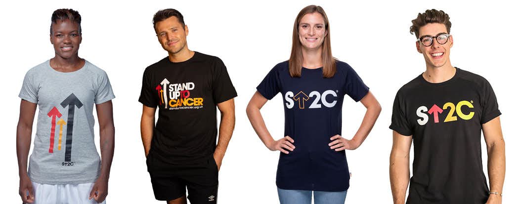 Four people wearing a variety of Stand Up To Cancer branded T-shirts.