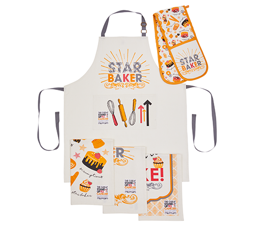 A photograph of an apron, oven gloves and tea towels, all showcasing the Stand Up To Cancer Logo and saying 'Star Baker'.