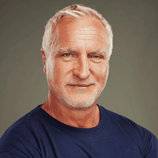 Headshot of David Ginola in a stand up to cancer t shirt.
